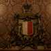 ...sormontato da una corona a cinque torri e sostenuta da due rami laterali dalloro e di quercia